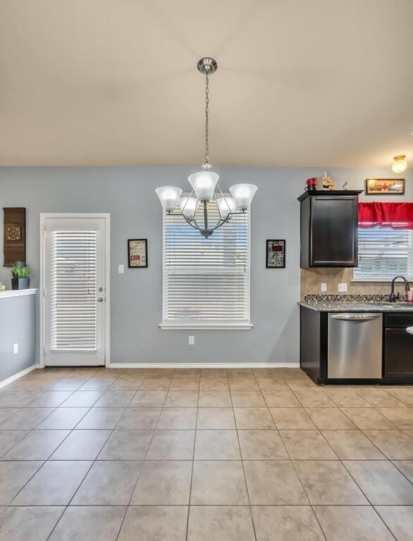 interior space featuring light tile patterned floors, a notable chandelier, and sink