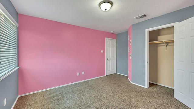 unfurnished bedroom with carpet and a closet