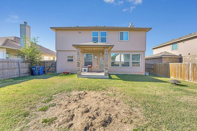 rear view of property featuring a yard