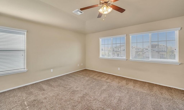 spare room with ceiling fan, carpet floors, and vaulted ceiling