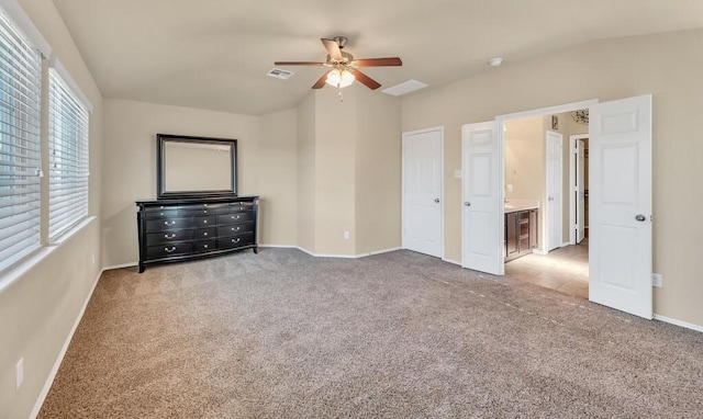 unfurnished bedroom featuring connected bathroom, ceiling fan, light carpet, and lofted ceiling