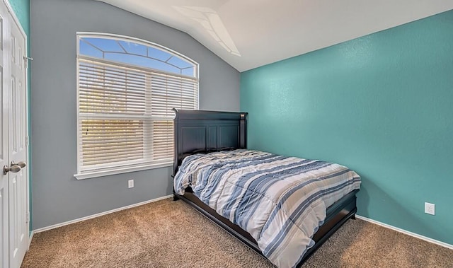 bedroom with carpet floors and vaulted ceiling