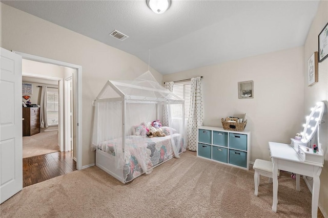 bedroom featuring a textured ceiling and carpet flooring