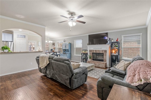 living room featuring dark wood-type flooring, a fireplace, and ornamental molding