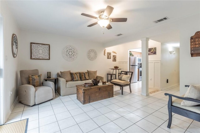 tiled living room with ceiling fan