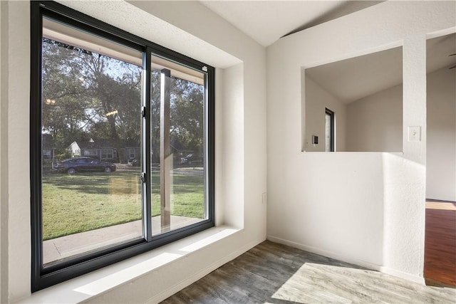 interior space featuring hardwood / wood-style floors and vaulted ceiling