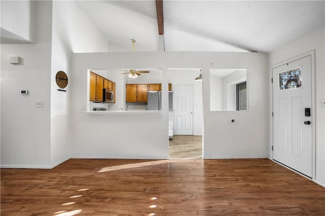 entrance foyer with dark wood-type flooring, high vaulted ceiling, ceiling fan, a textured ceiling, and beamed ceiling