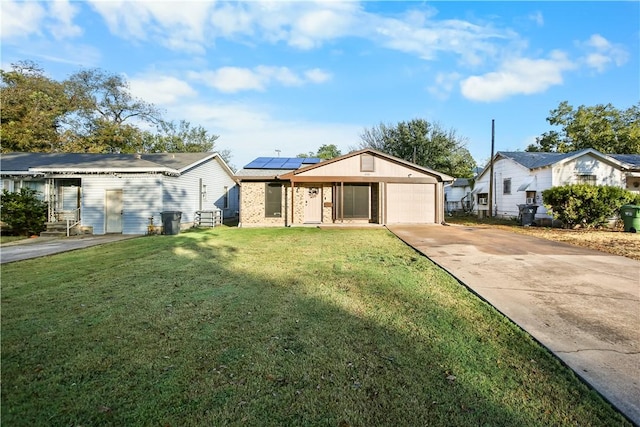 view of front facade with a front lawn, a garage, and solar panels