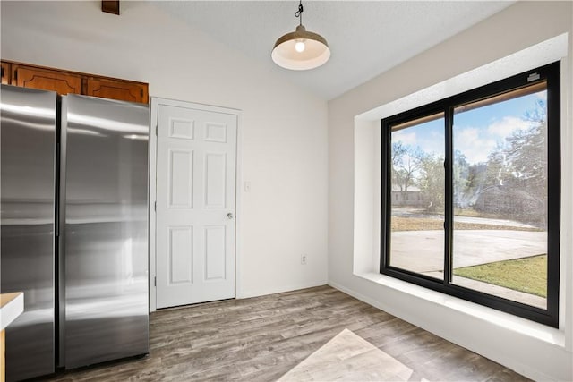 unfurnished dining area with light hardwood / wood-style flooring and a healthy amount of sunlight