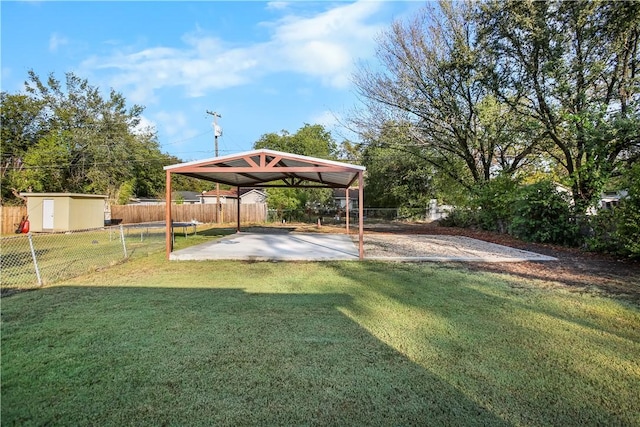 view of yard with a carport and a storage shed