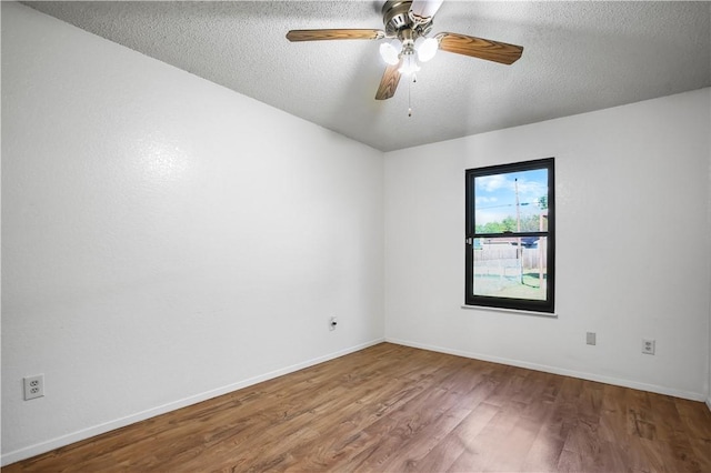 empty room featuring hardwood / wood-style floors, a textured ceiling, and ceiling fan