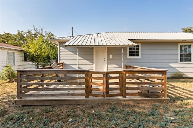 back of house with a wooden deck