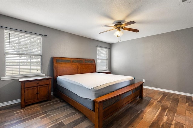 bedroom featuring a textured ceiling, ceiling fan, and dark hardwood / wood-style floors