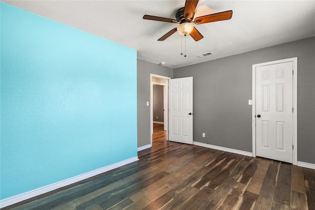 spare room with dark hardwood / wood-style floors and ceiling fan