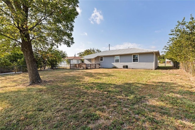 rear view of house with a yard and cooling unit