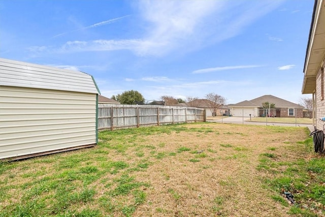 view of yard featuring a fenced backyard and an outbuilding