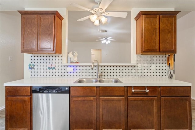 kitchen with tasteful backsplash, light countertops, dishwasher, and a sink