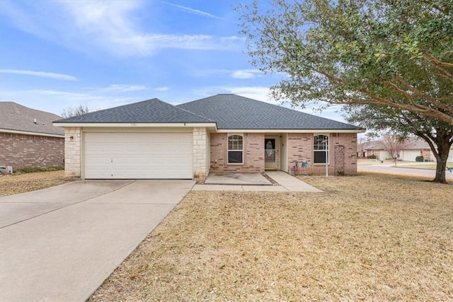 single story home with roof with shingles, brick siding, concrete driveway, a front yard, and a garage