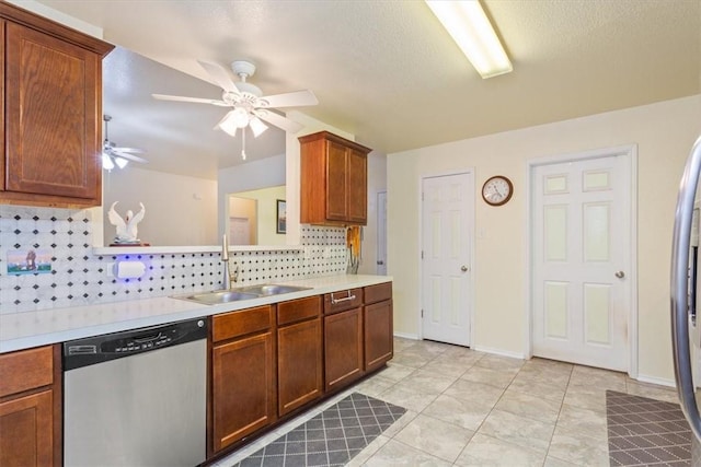 kitchen with light countertops, decorative backsplash, a sink, ceiling fan, and dishwasher