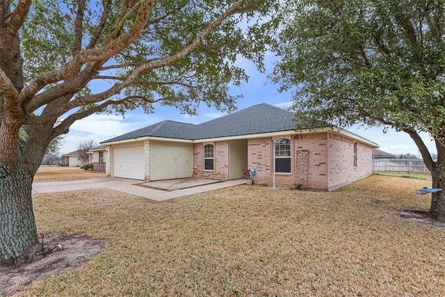 single story home featuring an attached garage, brick siding, fence, concrete driveway, and a front yard