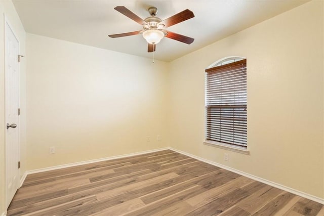 unfurnished room with ceiling fan, baseboards, and wood finished floors