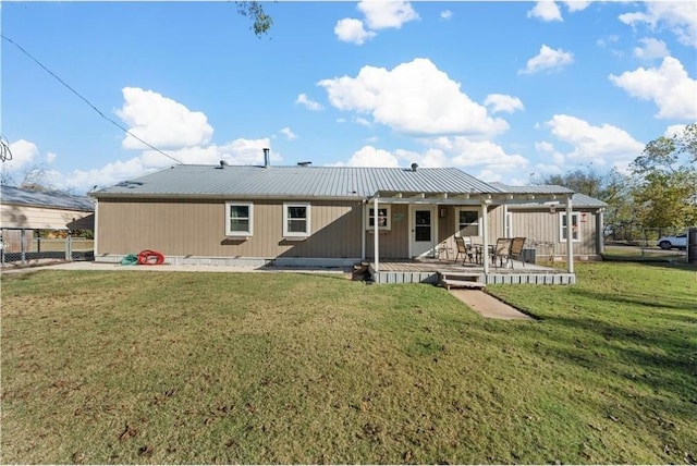 rear view of house with a yard and a deck