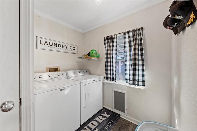 laundry area with washer and dryer, wood-type flooring, and ornamental molding