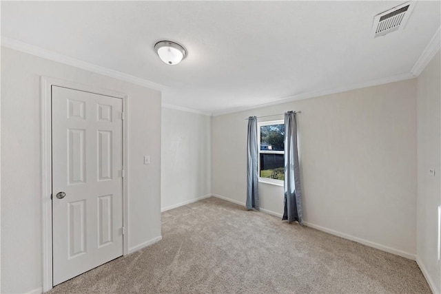 carpeted spare room with ornamental molding