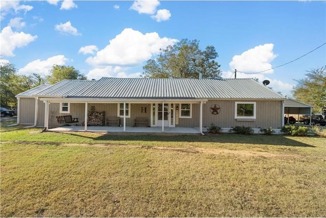 back of house with a lawn