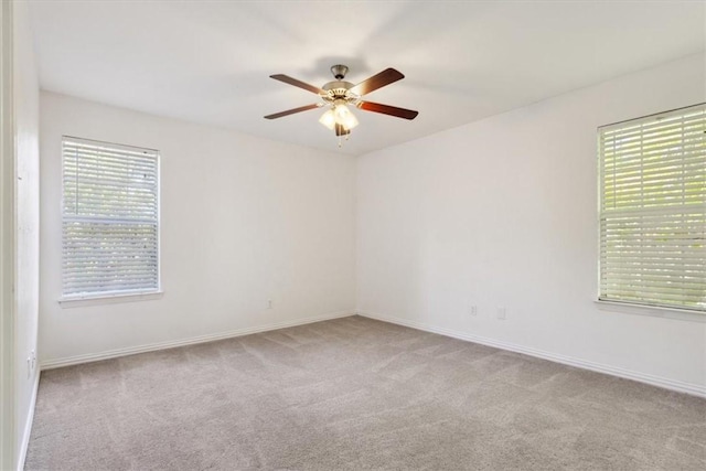 carpeted empty room featuring ceiling fan