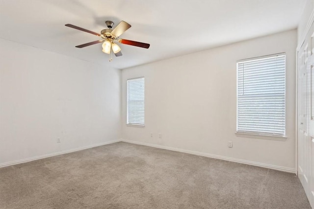 empty room with light colored carpet and ceiling fan