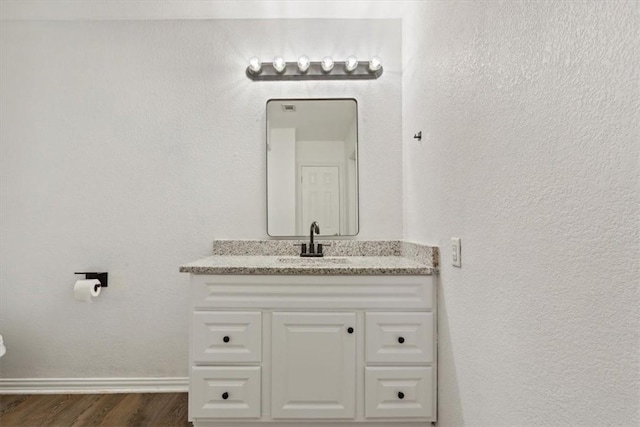 bathroom with vanity and hardwood / wood-style flooring