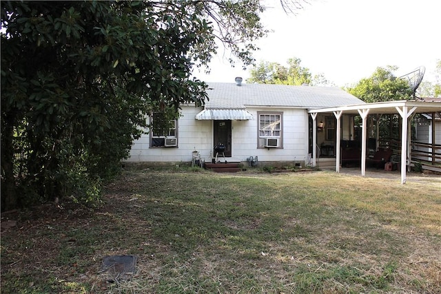 back of house featuring cooling unit and a lawn