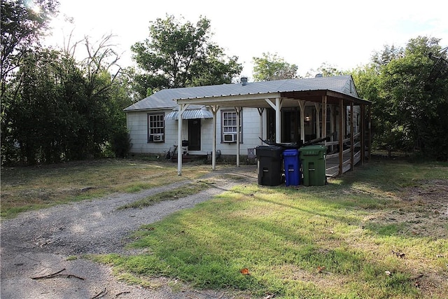 view of front of home with cooling unit and a front yard