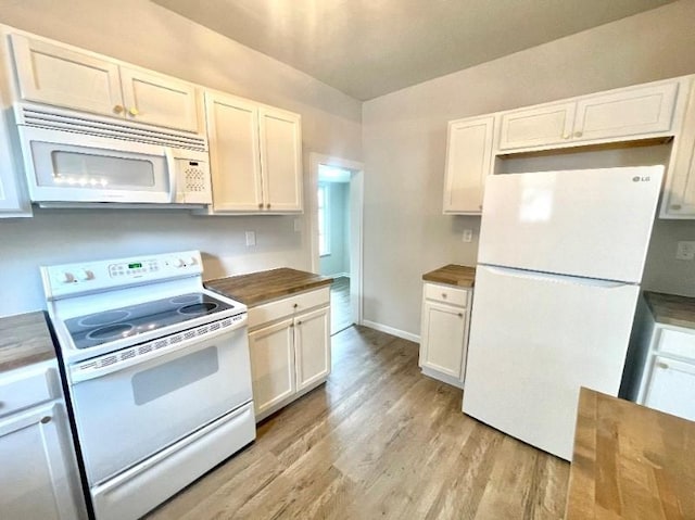 kitchen with wood counters, white appliances, light hardwood / wood-style flooring, and white cabinetry