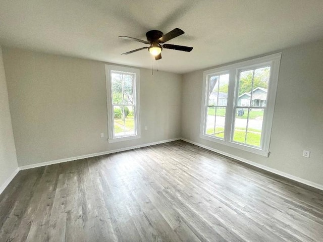 spare room with ceiling fan and wood-type flooring