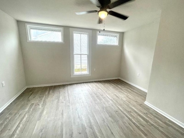 empty room featuring ceiling fan and hardwood / wood-style floors