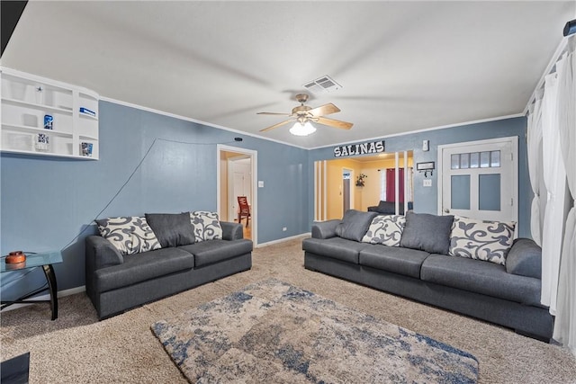 living room featuring ornamental molding, ceiling fan, and carpet