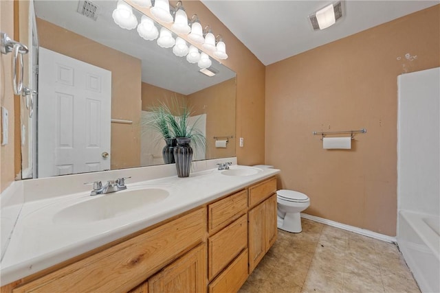 bathroom with vanity, toilet, and a bathing tub