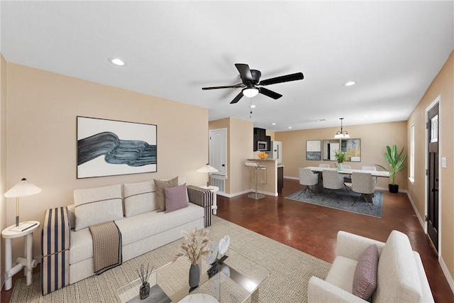 living room with recessed lighting, baseboards, concrete floors, and ceiling fan