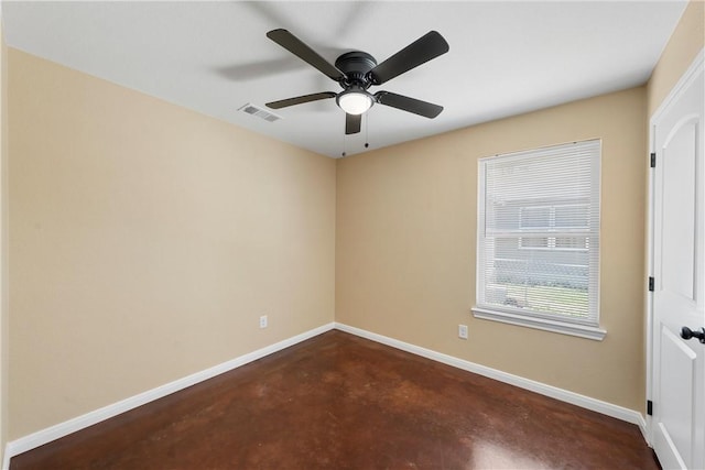 spare room with visible vents, baseboards, concrete floors, and ceiling fan