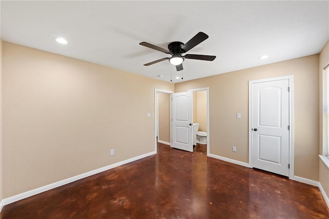 unfurnished bedroom with recessed lighting, connected bathroom, baseboards, and concrete flooring