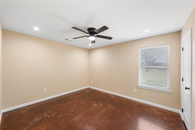 unfurnished room with visible vents, ceiling fan, concrete flooring, and baseboards