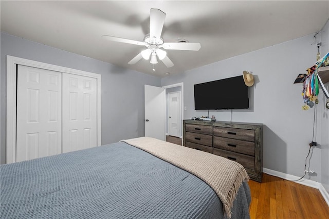 bedroom with ceiling fan, hardwood / wood-style floors, and a closet