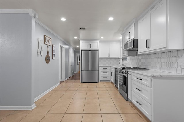 kitchen with stainless steel appliances, white cabinetry, ornamental molding, and light tile patterned floors