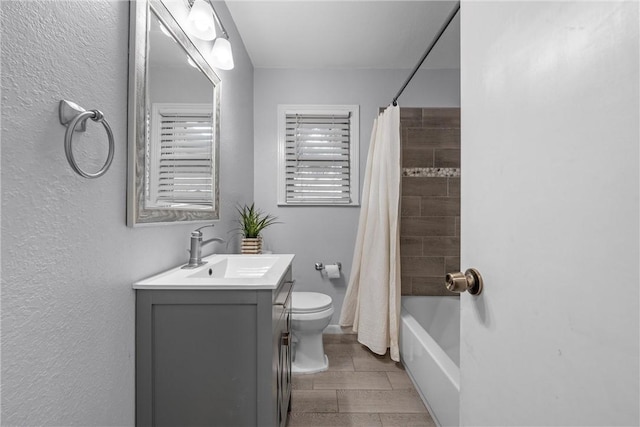 full bathroom featuring toilet, shower / bath combo, and vanity