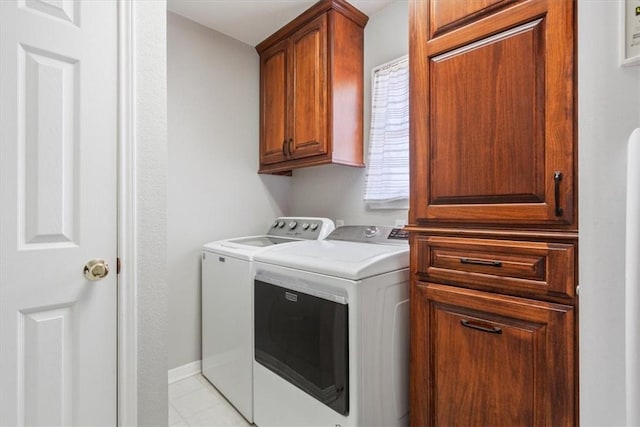 laundry area featuring cabinet space, baseboards, and separate washer and dryer