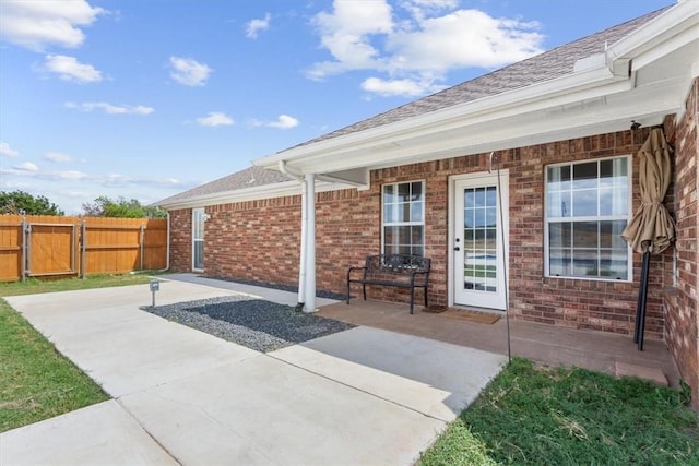 view of patio featuring a gate and fence