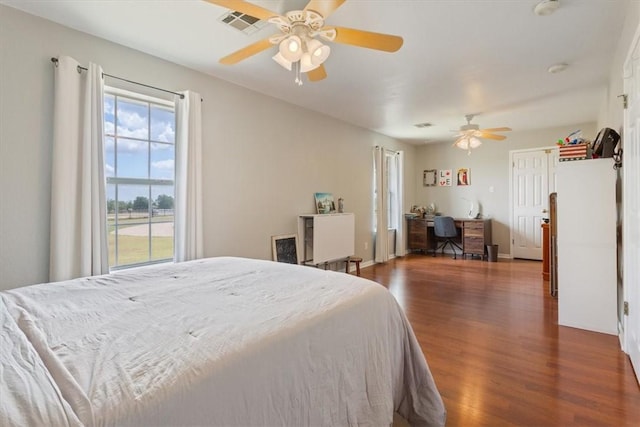 bedroom featuring baseboards, dark wood-style floors, visible vents, and ceiling fan