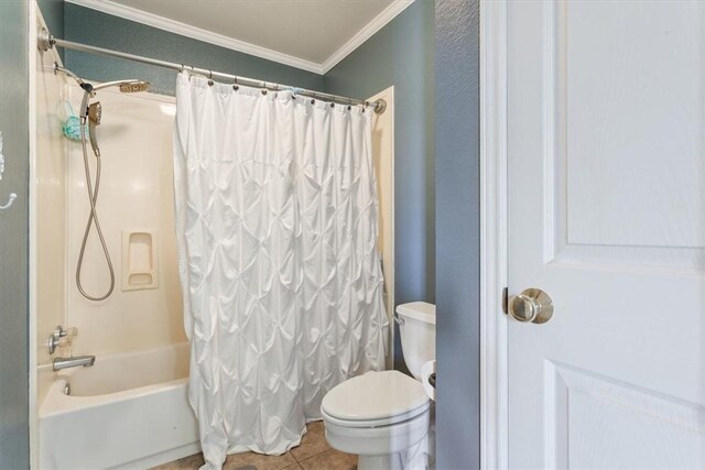 bathroom with tile patterned floors, toilet, shower / tub combo with curtain, and ornamental molding